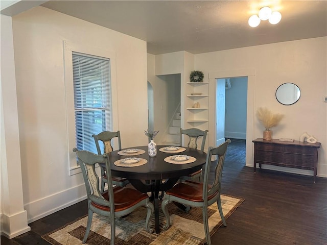 15 S Culver St, Chippewa Falls, WI 54729 - dining space with stairs, dark wood-type flooring, built in features, and arched walkways