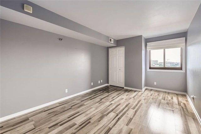 26 10th St Unit 1104, Saint Paul, MN 55102 - unfurnished bedroom with light wood-style floors and a closet