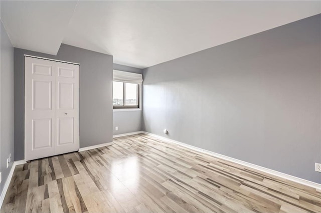 26 10th St Unit 1104, Saint Paul, MN 55102 - unfurnished bedroom featuring light wood-style floors and a closet