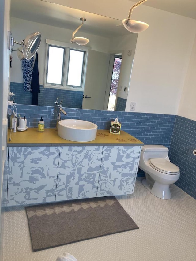 N155 Surfside Dr, Cedar Grove, WI 53013 - bathroom with tile walls, a wainscoted wall, vanity, and healthy amount of natural light