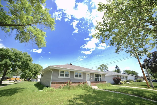 8750 W Hustis St, Milwaukee, WI 53224 - view of front of home with brick siding and a front yard