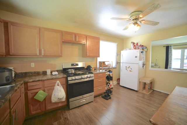 8750 W Hustis St, Milwaukee, WI 53224 - kitchen featuring freestanding refrigerator, stainless steel range with gas cooktop, ceiling fan, and wood finished floors