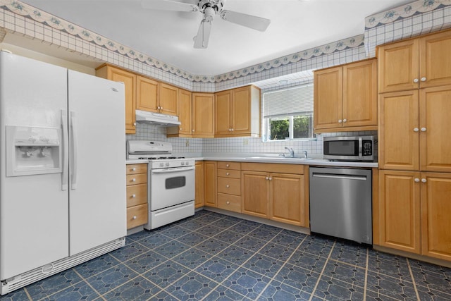 114 S Adam St, South Beloit, IL 61080 - kitchen with stainless steel appliances, under cabinet range hood, light countertops, decorative backsplash, and ceiling fan