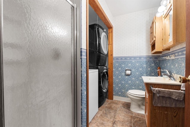 114 S Adam St, South Beloit, IL 61080 - bathroom featuring estacked washer and dryer, wallpapered walls, a stall shower, and vanity