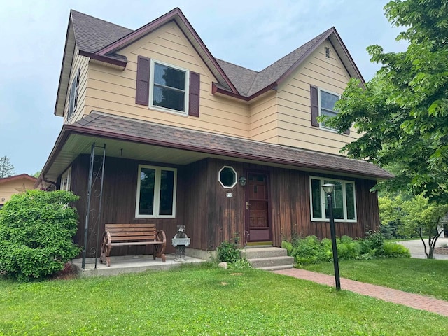 710 Jefferson St, Merrill, WI 54452 - view of front of house featuring roof with shingles and a front lawn