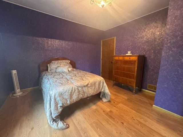 710 Jefferson St, Merrill, WI 54452 - bedroom featuring wood finished floors and a textured ceiling