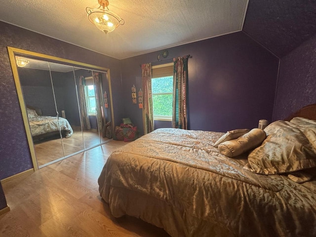 710 Jefferson St, Merrill, WI 54452 - bedroom with wood finished floors, a textured ceiling, a closet, and vaulted ceiling