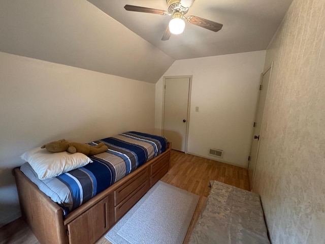 710 Jefferson St, Merrill, WI 54452 - bedroom featuring light wood-type flooring, vaulted ceiling, and ceiling fan
