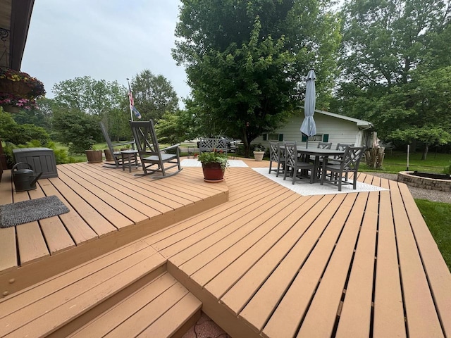 710 Jefferson St, Merrill, WI 54452 - wooden terrace with outdoor dining space and view of wooded area