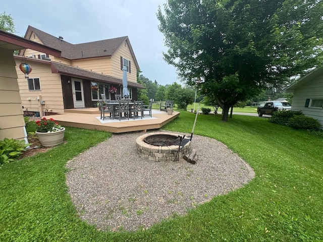 710 Jefferson St, Merrill, WI 54452 - view of green lawn featuring an outdoor fire pit, a wooden deck, and outdoor dining space