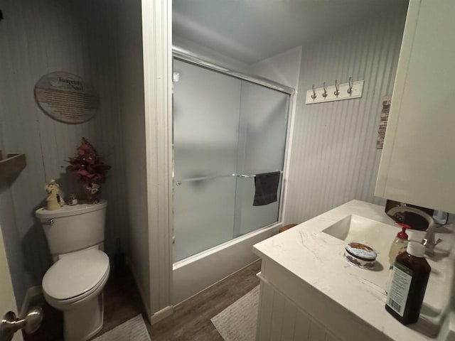 710 Jefferson St, Merrill, WI 54452 - bathroom featuring enclosed tub / shower combo, vanity, and wood finished floors