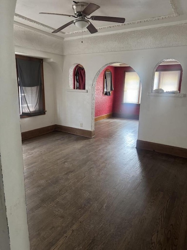 2320 W Hope Ave Unit 2320A, Milwaukee, WI 53209 - empty room with a tray ceiling, arched walkways, wood finished floors, and ceiling fan
