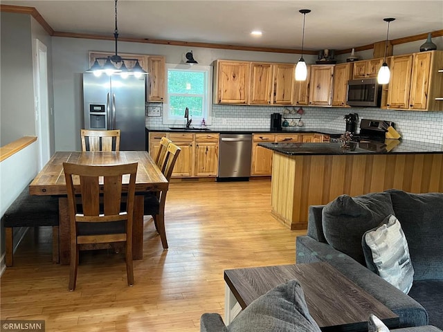 1283 230th Ave, Luck, WI 54853 - kitchen with appliances with stainless steel finishes, ornamental molding, dark countertops, and decorative backsplash