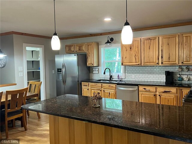 1283 230th Ave, Luck, WI 54853 - kitchen featuring appliances with stainless steel finishes, crown molding, backsplash, hanging light fixtures, and dark stone countertops