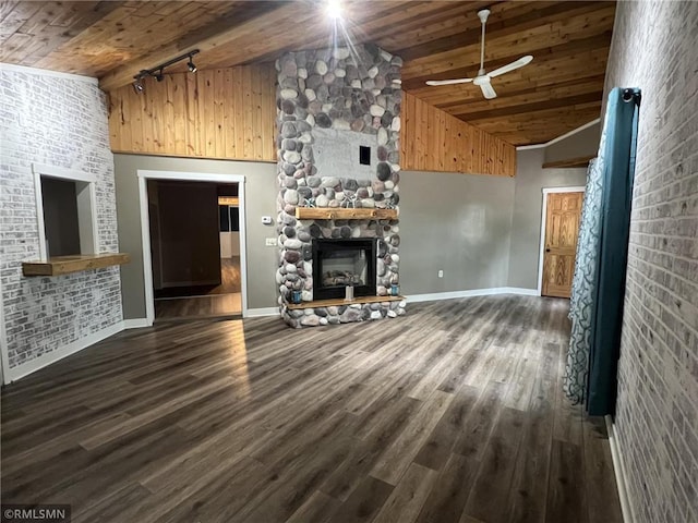 1283 230th Ave, Luck, WI 54853 - unfurnished living room featuring wood ceiling, track lighting, high vaulted ceiling, a stone fireplace, and wood finished floors