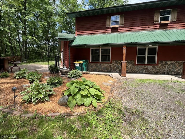 1283 230th Ave, Luck, WI 54853 - view of front of house featuring a porch, stone siding, and a metal roof