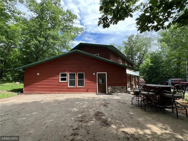 1283 230th Ave, Luck, WI 54853 - back of house with outdoor dining area and a patio area