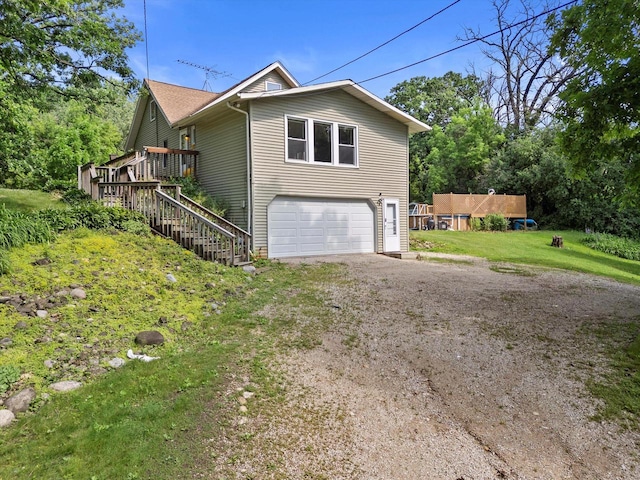 8020 Ridgeway Dr, Burlington, WI 53105 - view of home's exterior featuring dirt driveway, an attached garage, stairs, a wooden deck, and a lawn