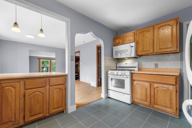 8020 Ridgeway Dr, Burlington, WI 53105 - kitchen with white appliances, decorative backsplash, light countertops, and brown cabinetry