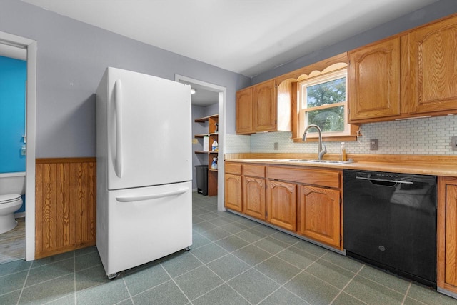 8020 Ridgeway Dr, Burlington, WI 53105 - kitchen with freestanding refrigerator, black dishwasher, light countertops, decorative backsplash, and wainscoting