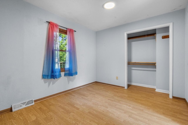 8020 Ridgeway Dr, Burlington, WI 53105 - unfurnished bedroom featuring wood finished floors and a closet