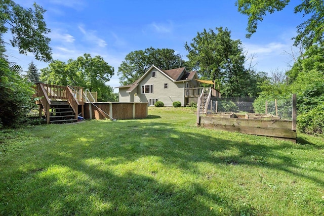 8020 Ridgeway Dr, Burlington, WI 53105 - view of green lawn featuring stairs, a vegetable garden, and a wooden deck