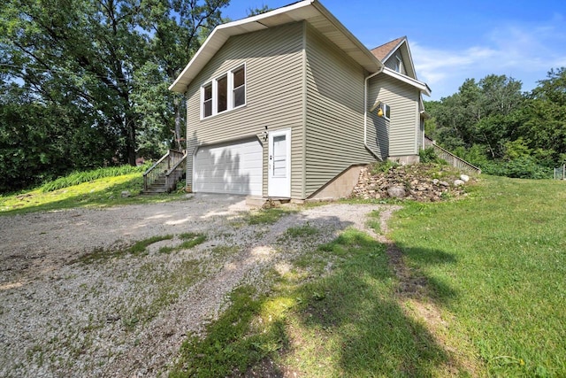 8020 Ridgeway Dr, Burlington, WI 53105 - view of property exterior featuring driveway, stairs, an attached garage, and a lawn