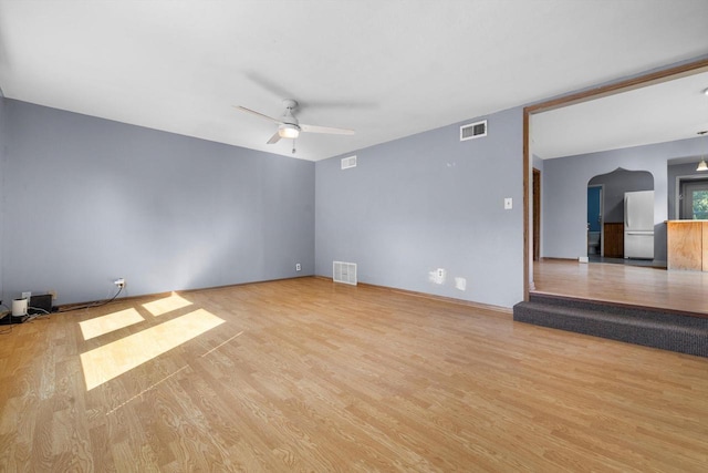 8020 Ridgeway Dr, Burlington, WI 53105 - spare room with wood finished floors, a ceiling fan, and arched walkways