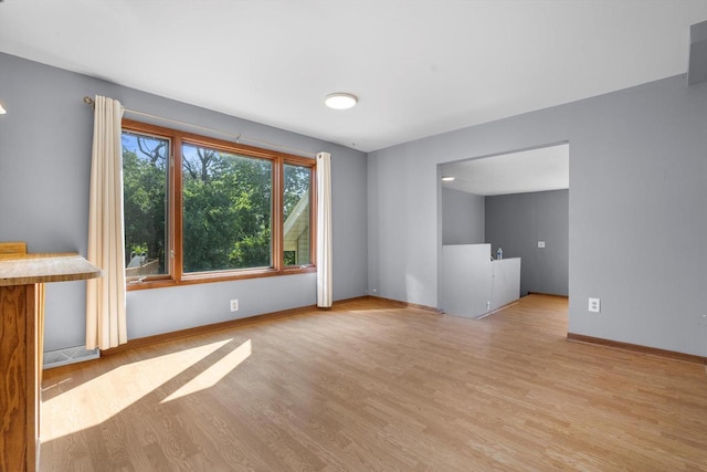 8020 Ridgeway Dr, Burlington, WI 53105 - unfurnished living room with wood finished floors and baseboards