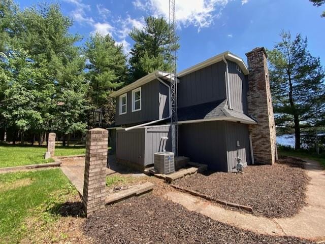 202361 Dubay Dr, Mosinee, WI 54455 - view of side of home featuring a chimney and board and batten siding