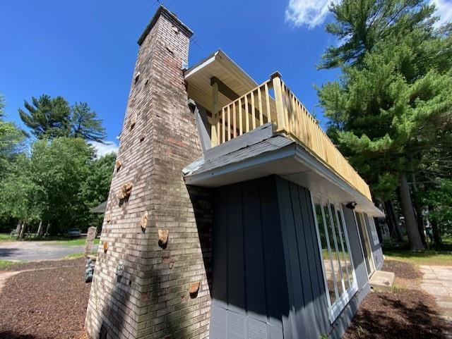 202361 Dubay Dr, Mosinee, WI 54455 - view of side of property with a balcony, a chimney, and board and batten siding