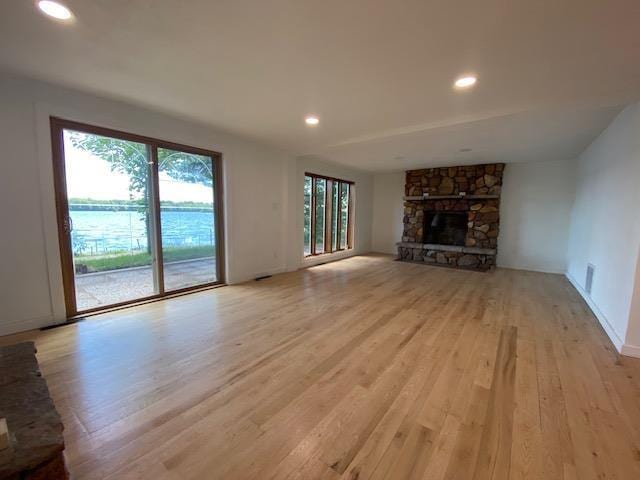 202361 Dubay Dr, Mosinee, WI 54455 - unfurnished living room with light wood finished floors, a fireplace, and recessed lighting