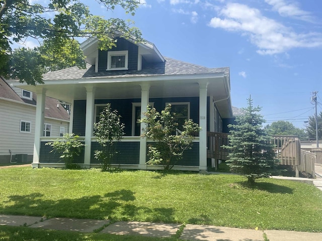 510 S Vine Ave, Marshfield, WI 54449 - view of home's exterior with a porch, a lawn, and roof with shingles