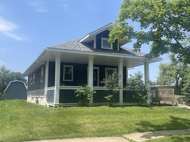 510 S Vine Ave, Marshfield, WI 54449 - rear view of house with covered porch, a lawn, a storage shed, and a shingled roof