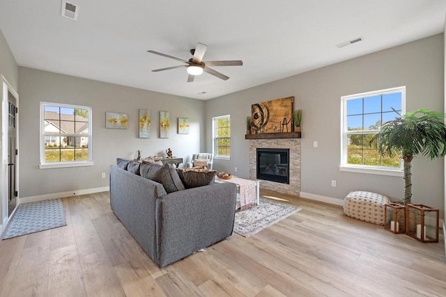 1883 Woodland Way, Slinger, WI 53086 - living room featuring light wood-style flooring, ceiling fan, plenty of natural light, and a fireplace