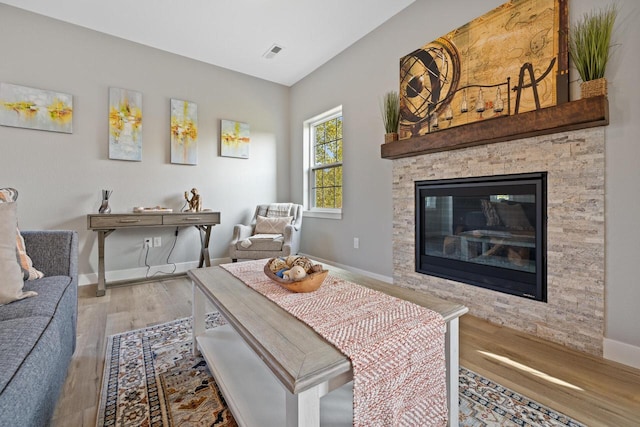 1883 Woodland Way, Slinger, WI 53086 - living room featuring wood finished floors and a stone fireplace