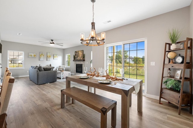 1883 Woodland Way, Slinger, WI 53086 - dining room featuring a chandelier, light wood-style floors, plenty of natural light, and ceiling fan