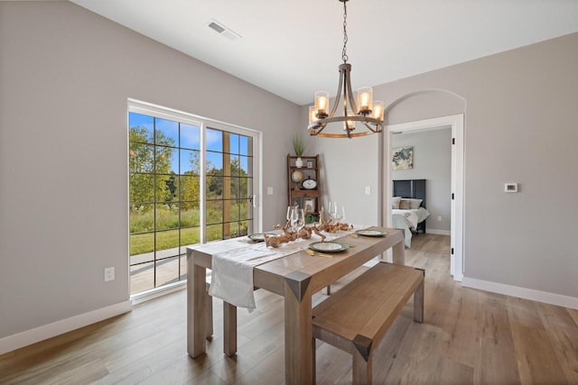 1883 Woodland Way, Slinger, WI 53086 - dining area featuring a chandelier and light wood-style floors