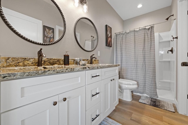 1883 Woodland Way, Slinger, WI 53086 - bathroom with wood finished floors, vanity, a shower with curtain, and recessed lighting