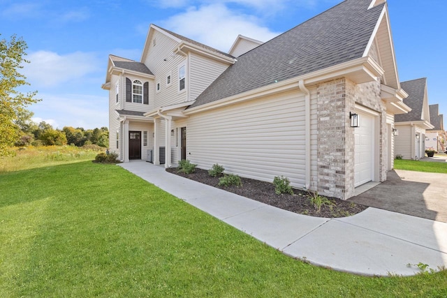 1883 Woodland Way, Slinger, WI 53086 - view of front of property featuring a shingled roof, a front yard, a garage, and driveway