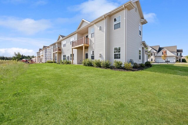 1883 Woodland Way, Slinger, WI 53086 - back of house with a balcony and a lawn