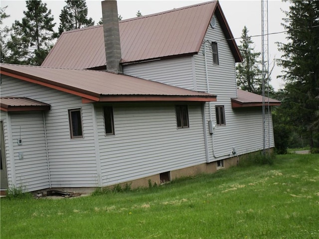 W7753 Old 14 Rd, Ladysmith, WI 54848 - view of side of home featuring a chimney, a yard, and a metal roof