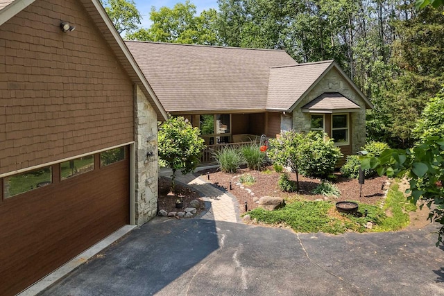 14900 Lax Chapel Rd, Kiel, WI 53042 - view of front of property with stone siding, asphalt driveway, and a garage