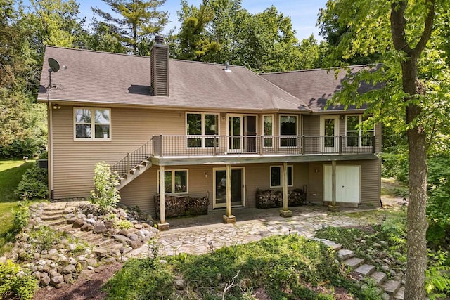 14900 Lax Chapel Rd, Kiel, WI 53042 - rear view of house with a chimney, a deck, stairway, a patio area, and roof with shingles