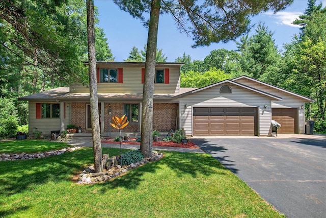 5111 Timberland Trl, Wisconsin Rapids, WI 54494 - traditional home with driveway, a garage, a front yard, and brick siding