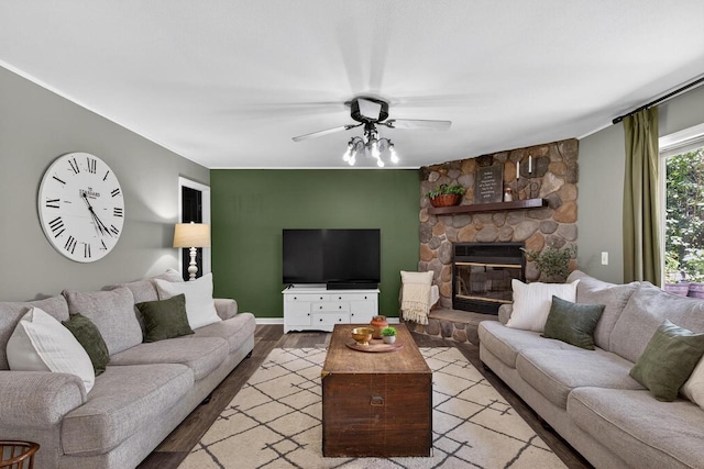 5111 Timberland Trl, Wisconsin Rapids, WI 54494 - living room with wood finished floors, a ceiling fan, and a stone fireplace