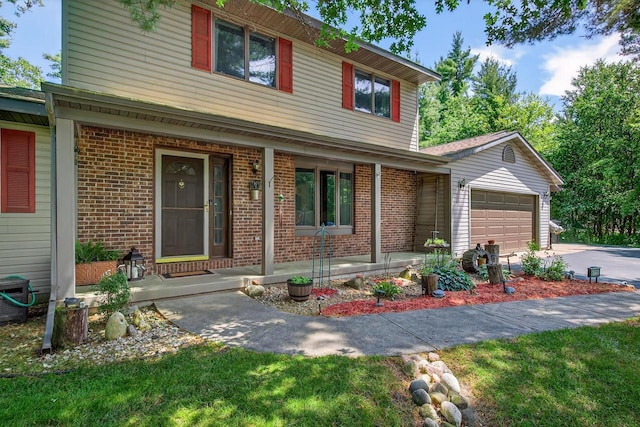5111 Timberland Trl, Wisconsin Rapids, WI 54494 - traditional-style house featuring covered porch, brick siding, an attached garage, and concrete driveway