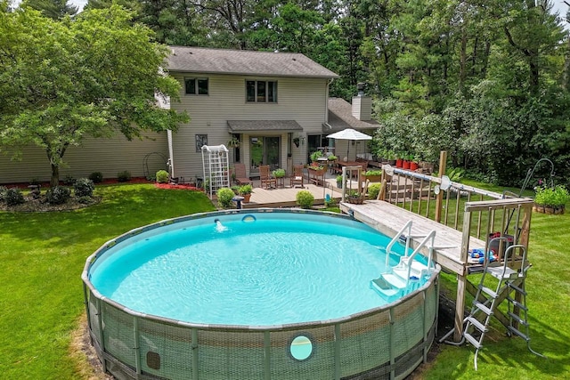 5111 Timberland Trl, Wisconsin Rapids, WI 54494 - swimming pool with a deck, a yard, and view of wooded area