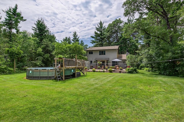 5111 Timberland Trl, Wisconsin Rapids, WI 54494 - view of grassy yard featuring an outdoor pool, view of scattered trees, and a wooden deck