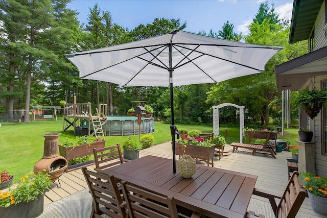 5111 Timberland Trl, Wisconsin Rapids, WI 54494 - wooden deck featuring outdoor dining space, an outdoor pool, a yard, and view of wooded area